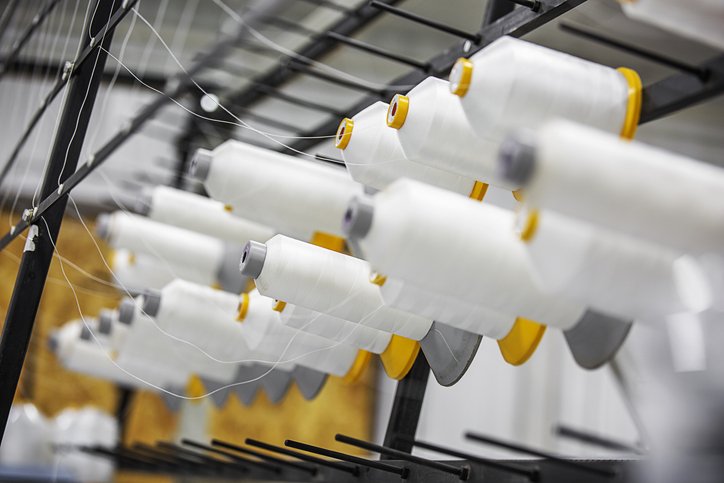 Equipment with spools of white yarn